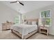 Bright bedroom with a vaulted ceiling, neutral decor, and well-lit windows at 2727 4 Winds Pl, Mount Pleasant, SC 29466