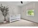 Bright bedroom features a large window, neutral walls, and a charming white crib at 2727 4 Winds Pl, Mount Pleasant, SC 29466