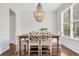 Formal dining room with a large window, a rustic-style table, and decorative chandelier at 2727 4 Winds Pl, Mount Pleasant, SC 29466