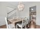 Elegant dining room with a stylish chandelier, a wooden table, and seating for six guests at 2727 4 Winds Pl, Mount Pleasant, SC 29466