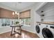 Cozy eat-in kitchen nook with a rustic wooden table, bright windows, and a nearby laundry area at 2727 4 Winds Pl, Mount Pleasant, SC 29466