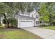 Charming two-story home with a two-car garage, landscaped yard, and manicured lawn at 2727 4 Winds Pl, Mount Pleasant, SC 29466