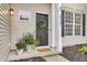 Inviting front door adorned with a wreath, complemented by potted plants and stylish house numbers at 2727 4 Winds Pl, Mount Pleasant, SC 29466