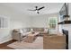 Inviting living room featuring a large sectional sofa, fireplace, and bright windows at 2727 4 Winds Pl, Mount Pleasant, SC 29466