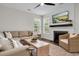 Cozy living room with a fireplace, shiplap accent wall, and comfortable sectional sofa at 2727 4 Winds Pl, Mount Pleasant, SC 29466