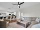 Open-concept living area with a modern ceiling fan, kitchen bar, and comfortable seating at 2727 4 Winds Pl, Mount Pleasant, SC 29466