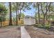 Backyard featuring a convenient storage shed with a charming walkway, surrounded by lush landscaping and mature trees at 2727 4 Winds Pl, Mount Pleasant, SC 29466