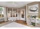 Inviting sunroom with natural light, neutral decor, oyster painting, and a playful ambiance at 2727 4 Winds Pl, Mount Pleasant, SC 29466