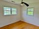 Bedroom with hardwood floors, white walls, and natural light from the windows at 2734 Mona Ave, Charleston, SC 29414