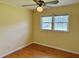 Bedroom with hardwood floors, ceiling fan, and natural light from double windows at 2734 Mona Ave, Charleston, SC 29414