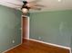 Bedroom featuring hardwood floors, ceiling fan, and muted green walls at 2734 Mona Ave, Charleston, SC 29414