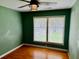 Bedroom with hardwood floors, ceiling fan, and natural light from the large window at 2734 Mona Ave, Charleston, SC 29414
