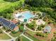 Aerial view of community pool with a water park, clubhouse and tropical landscaping at 2981 Sturbridge Rd, Mount Pleasant, SC 29466