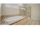 Bright bathroom featuring soaking tub, glass enclosed shower, and window with sunrise view at 2981 Sturbridge Rd, Mount Pleasant, SC 29466