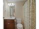 Bathroom featuring a wood vanity and framed mirror, next to a shower-tub with patterned curtain at 2981 Sturbridge Rd, Mount Pleasant, SC 29466