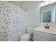 A charming bathroom featuring a polka dot shower curtain, white vanity, and modern mirror at 2981 Sturbridge Rd, Mount Pleasant, SC 29466