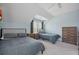 A cozy bedroom with two beds, blue walls, and light gray carpet is naturally lit at 2981 Sturbridge Rd, Mount Pleasant, SC 29466