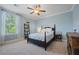 Cozy bedroom with plush carpet, ceiling fan, and a large sunny window at 2981 Sturbridge Rd, Mount Pleasant, SC 29466