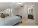 Bedroom leading to en suite bath with wood bed frame and neutral carpet at 2981 Sturbridge Rd, Mount Pleasant, SC 29466