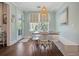 Well-lit dining area featuring a wooden table, white chairs, and large window overlooking greenery, bathed in natural light at 2981 Sturbridge Rd, Mount Pleasant, SC 29466