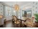 Sunlit dining room with a wooden table, beaded chandelier, patterned wallpaper and visible office space at 2981 Sturbridge Rd, Mount Pleasant, SC 29466