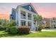 A two-story home featuring large white columns, lush landscaping, and a beautiful lawn at 2981 Sturbridge Rd, Mount Pleasant, SC 29466