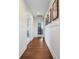 Hallway featuring beautiful hardwood floors, classic wainscoting and stylish framed artwork at 2981 Sturbridge Rd, Mount Pleasant, SC 29466