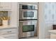 Stainless steel double wall oven with digital display, surrounded by white cabinets and decorative wallpaper at 2981 Sturbridge Rd, Mount Pleasant, SC 29466