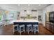 Modern kitchen with white cabinets, blue island, stainless steel appliances, and eat-in area at 2981 Sturbridge Rd, Mount Pleasant, SC 29466