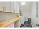 Well-organized laundry room featuring white cabinetry, butcher block counters, and modern appliances at 2981 Sturbridge Rd, Mount Pleasant, SC 29466