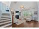 Inviting living room with staircase, cozy seating, fireplace, built-in shelves, and natural light from the windows at 2981 Sturbridge Rd, Mount Pleasant, SC 29466