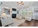 Comfortable living room with a fireplace, built-in shelves, large windows, and cozy seating arrangement on hardwood floors at 2981 Sturbridge Rd, Mount Pleasant, SC 29466