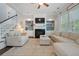 Bright living room with a fireplace, built-in shelves, large windows, and comfortable seating arrangement at 2981 Sturbridge Rd, Mount Pleasant, SC 29466