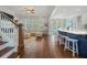 Open-concept living space featuring a plush couch, stairs, and kitchen island with seating at 2981 Sturbridge Rd, Mount Pleasant, SC 29466