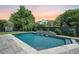 Beautiful in-ground pool with stone deck, lush landscaping, and serene backyard setting at 2981 Sturbridge Rd, Mount Pleasant, SC 29466