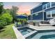 Pool and spa with stone decking and patio featuring BBQ grill and landscaping at 2981 Sturbridge Rd, Mount Pleasant, SC 29466