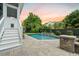 In-ground pool with manicured landscaping, stone accents, and a charming backyard view at 2981 Sturbridge Rd, Mount Pleasant, SC 29466