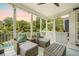 Relax on the screened porch featuring woven chairs, seating, and views of the backyard and pool at 2981 Sturbridge Rd, Mount Pleasant, SC 29466