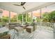 Enjoy outdoor living on this screened-in porch with comfortable seating and a ceiling fan at 2981 Sturbridge Rd, Mount Pleasant, SC 29466