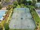 Aerial view of well-maintained tennis courts with lighting for evening play and mature landscaping at 2981 Sturbridge Rd, Mount Pleasant, SC 29466