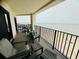 Balcony with ocean view with seating area and black metal railing at 311 Seascape (Share G), Isle of Palms, SC 29451