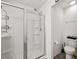 Bathroom featuring a glass shower, toilet, and white cabinets at 328 Surfbird Rd, Summerville, SC 29486