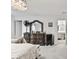 This bedroom has light carpet, a dark vanity, a large mirror, and a chandelier at 328 Surfbird Rd, Summerville, SC 29486