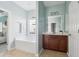 Bathroom featuring a soaking tub with a window, a wood vanity, and tile flooring at 3807 Canary Ct, North Charleston, SC 29420