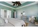 Spacious bedroom with tray ceiling, ceiling fan, sitting area, and ensuite bathroom at 3807 Canary Ct, North Charleston, SC 29420