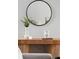 Close-up of a stylish console table with decorative vases and a round mirror at 3807 Canary Ct, North Charleston, SC 29420