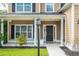 Close-up showcasing the home's welcoming front porch with classic columns, a dark door, and manicured landscaping at 3807 Canary Ct, North Charleston, SC 29420