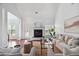 Open living room with a fireplace, large windows, and tasteful decor with lots of natural light at 3807 Canary Ct, North Charleston, SC 29420