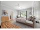 Bright bedroom with neutral walls, ceiling fan, plush bedding, and hardwood floors at 3872 James Bay Road, Johns Island, SC 29455