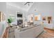 Bright living room with vaulted ceilings, fireplace, modern furniture, and wood floors at 3872 James Bay Road, Johns Island, SC 29455